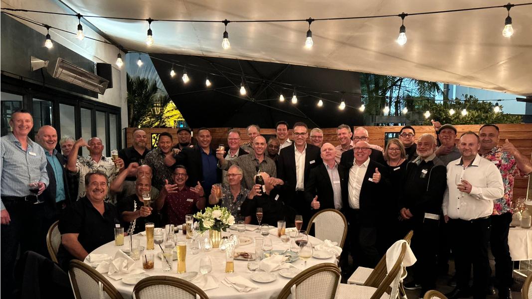 A group of people at a restaurant smile at the camera